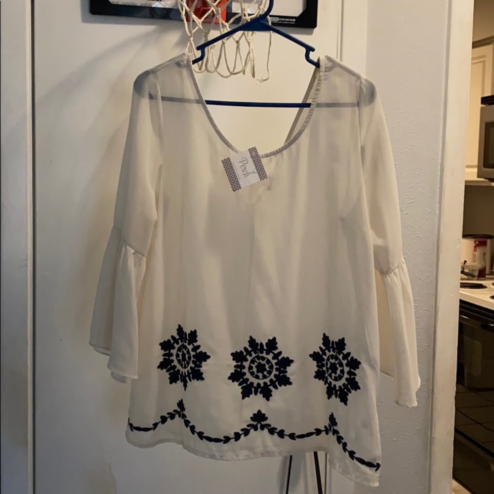 Sheer ivory/cream blouse with decorative design